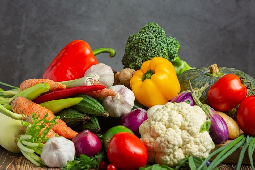 A spread of fresh vegetables on a wooden table